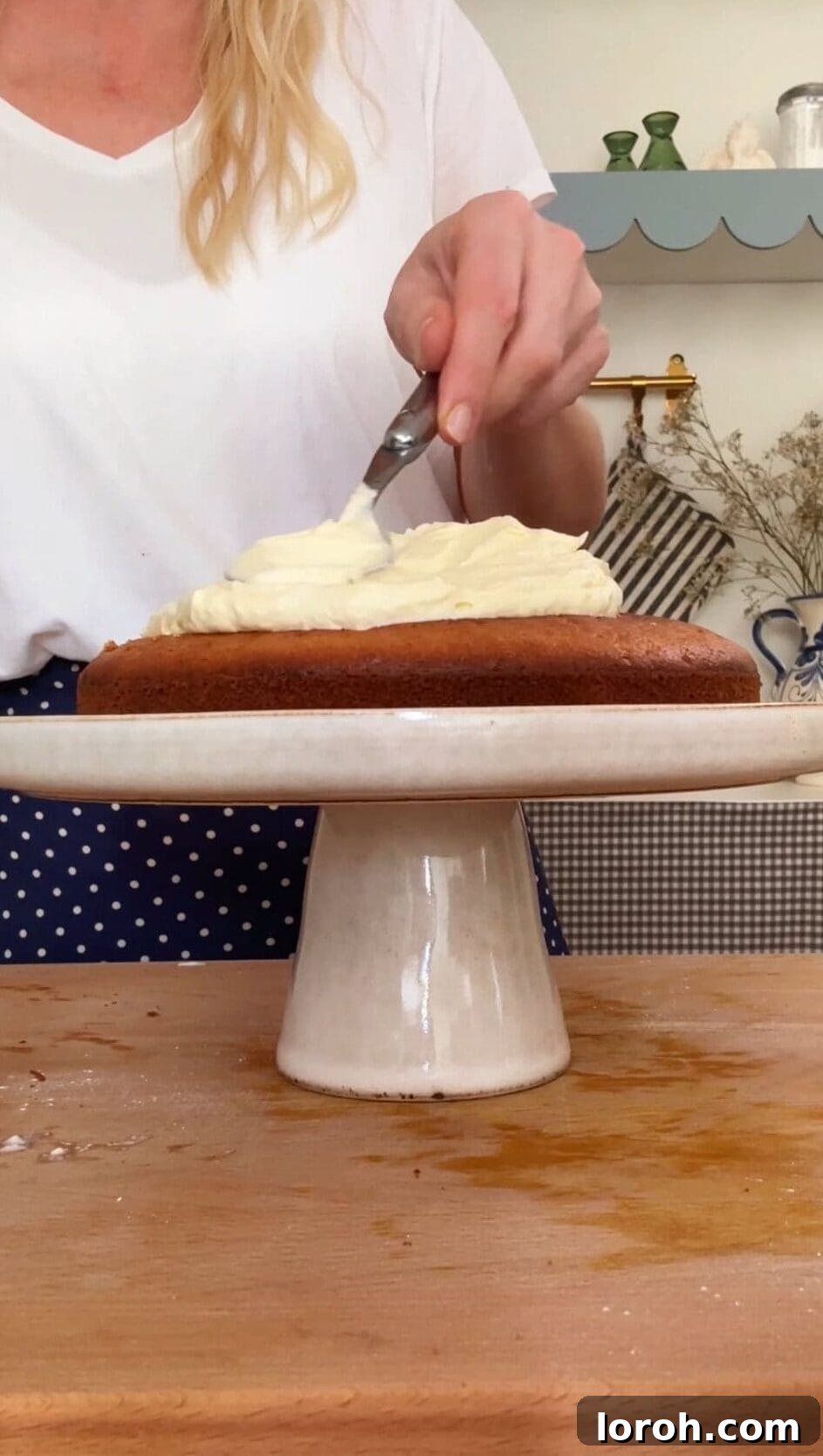 French Yogurt Cake The Easiest No Measure Treat 7 A decorated Gâteau au Yaourt on a flat plate, topped with whipped cream, fresh berries, and a dusting of icing sugar.