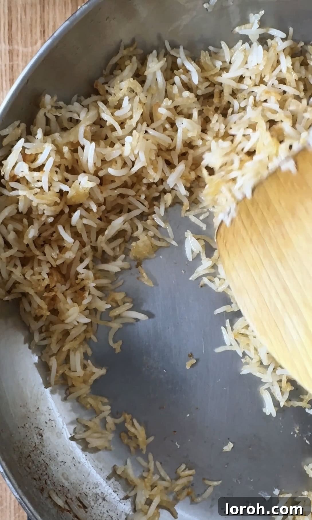 Salmon Crunch Bowl 9 frying day old rice in a silver pan.