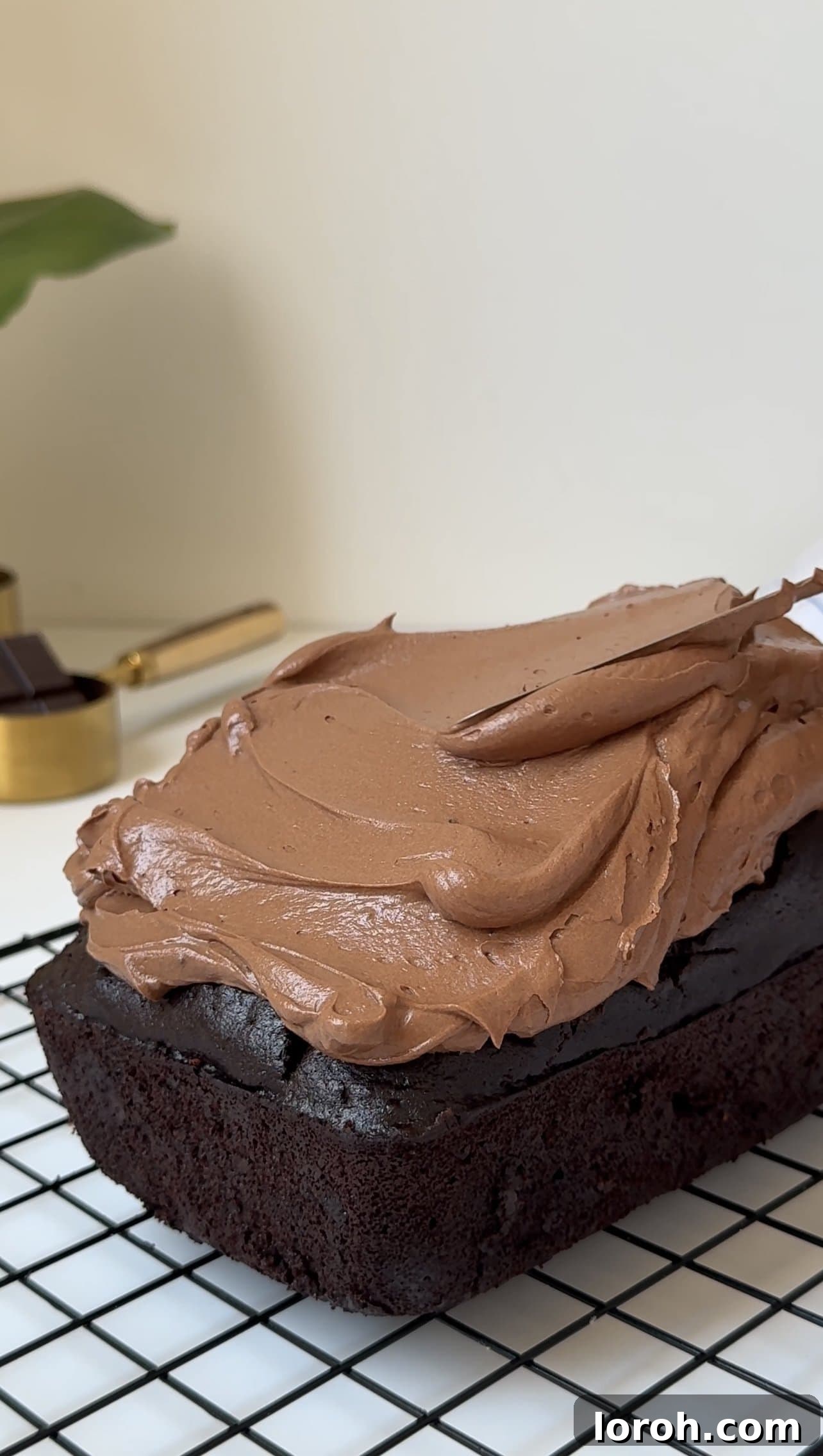 Fudgy Chocolate Zucchini Cake 4 A delicious chocolate courgette cake, freshly baked and perfectly formed in a loaf pan.