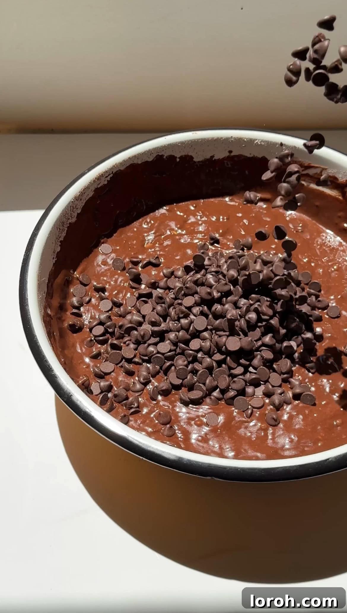 Fudgy Chocolate Zucchini Cake 8 Roughly chopped dark chocolate chunks being folded into the rich chocolate courgette cake batter.