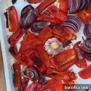 Velvety Roasted Red Pepper Sauce 8 Roasted red bell peppers, onions, and garlic on a baking tray before being blended into a creamy sauce.