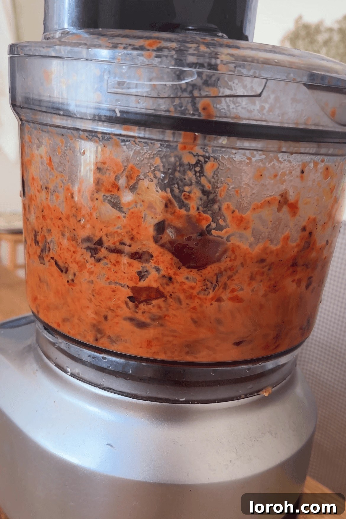 Velvety Roasted Red Pepper Sauce 5 Roasted vegetables cooling on a baking tray, with a food processor in the background ready for blending.