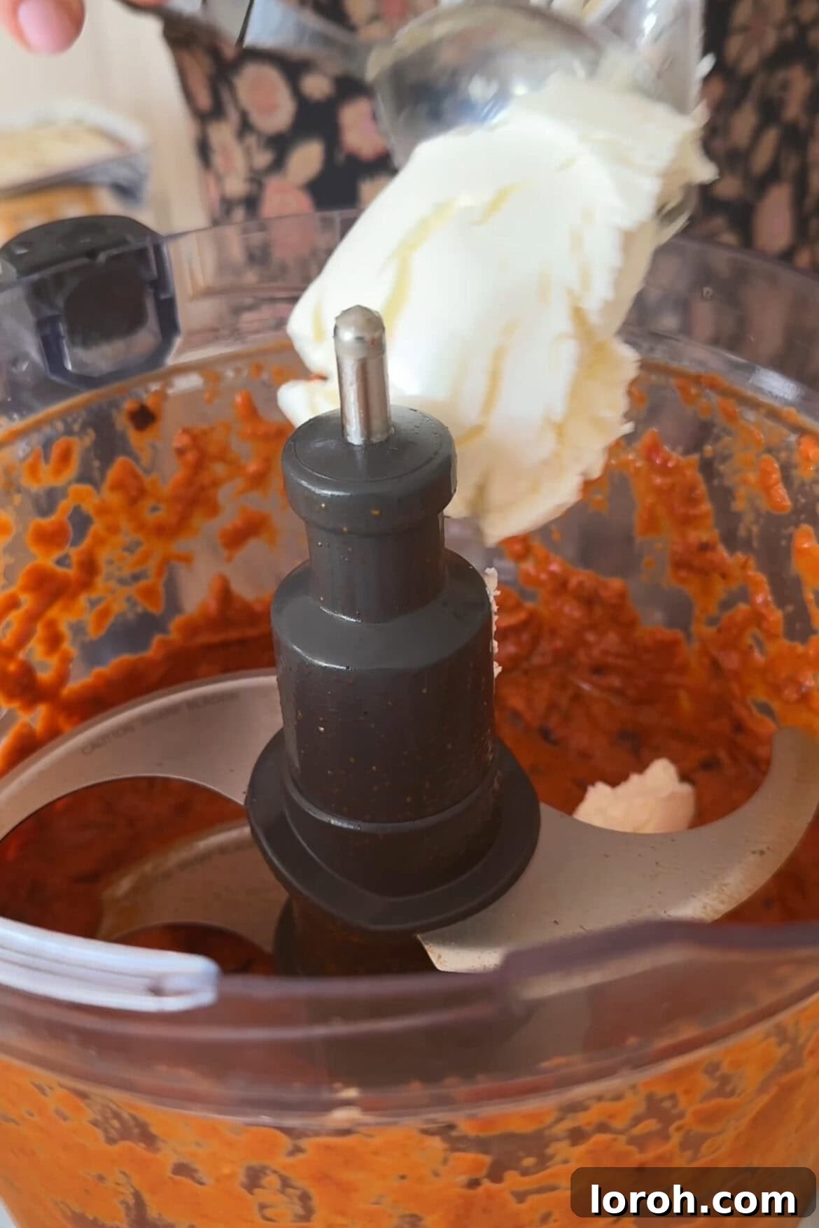 Velvety Roasted Red Pepper Sauce 6 Adding creamy mascarpone cheese to the blended roasted red bell pepper sauce in a food processor.