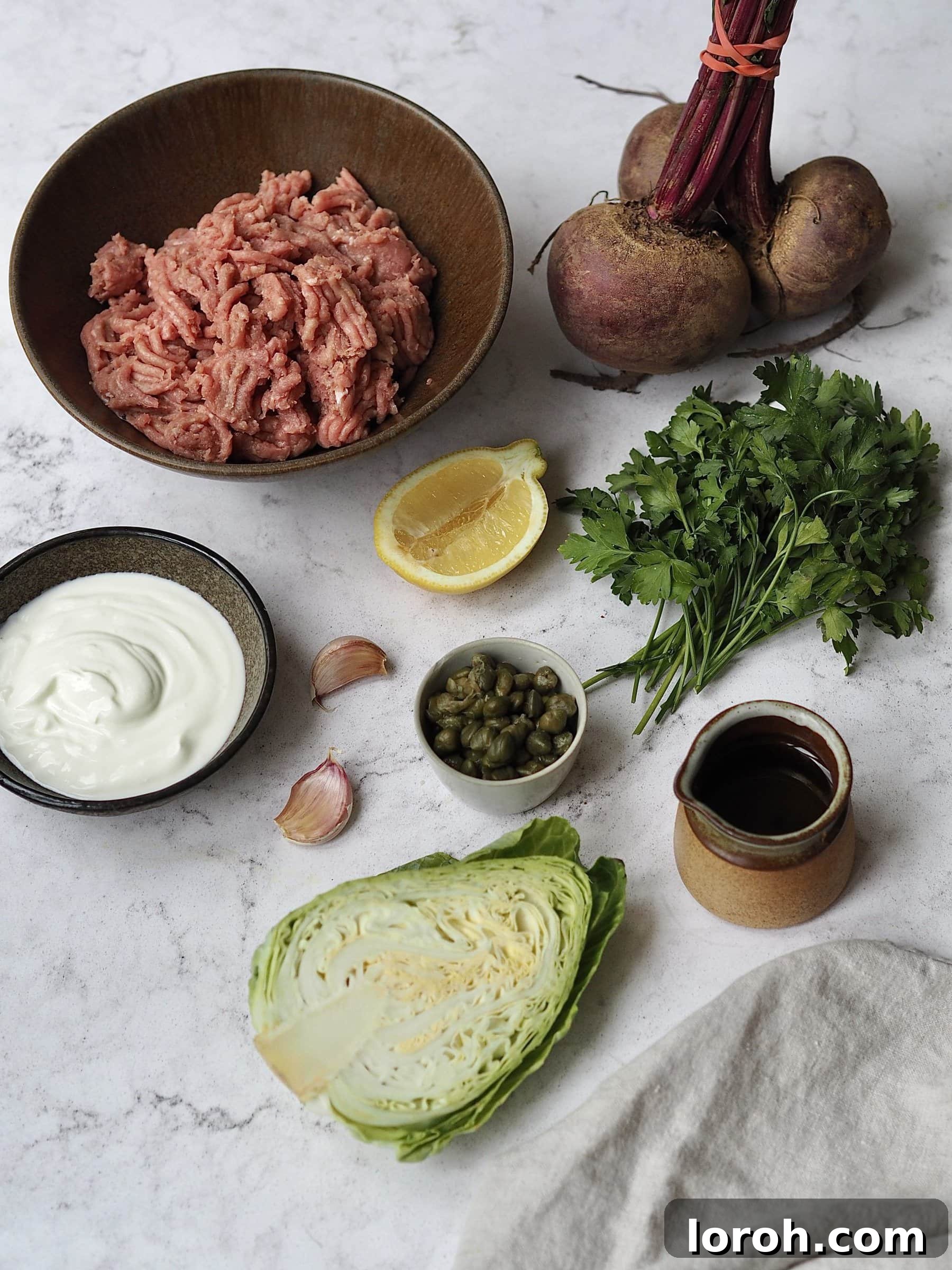 Ingredients laid out on a wooden board to make Salsa Verde Chicken Burgers with Zesty Yogurt Slaw