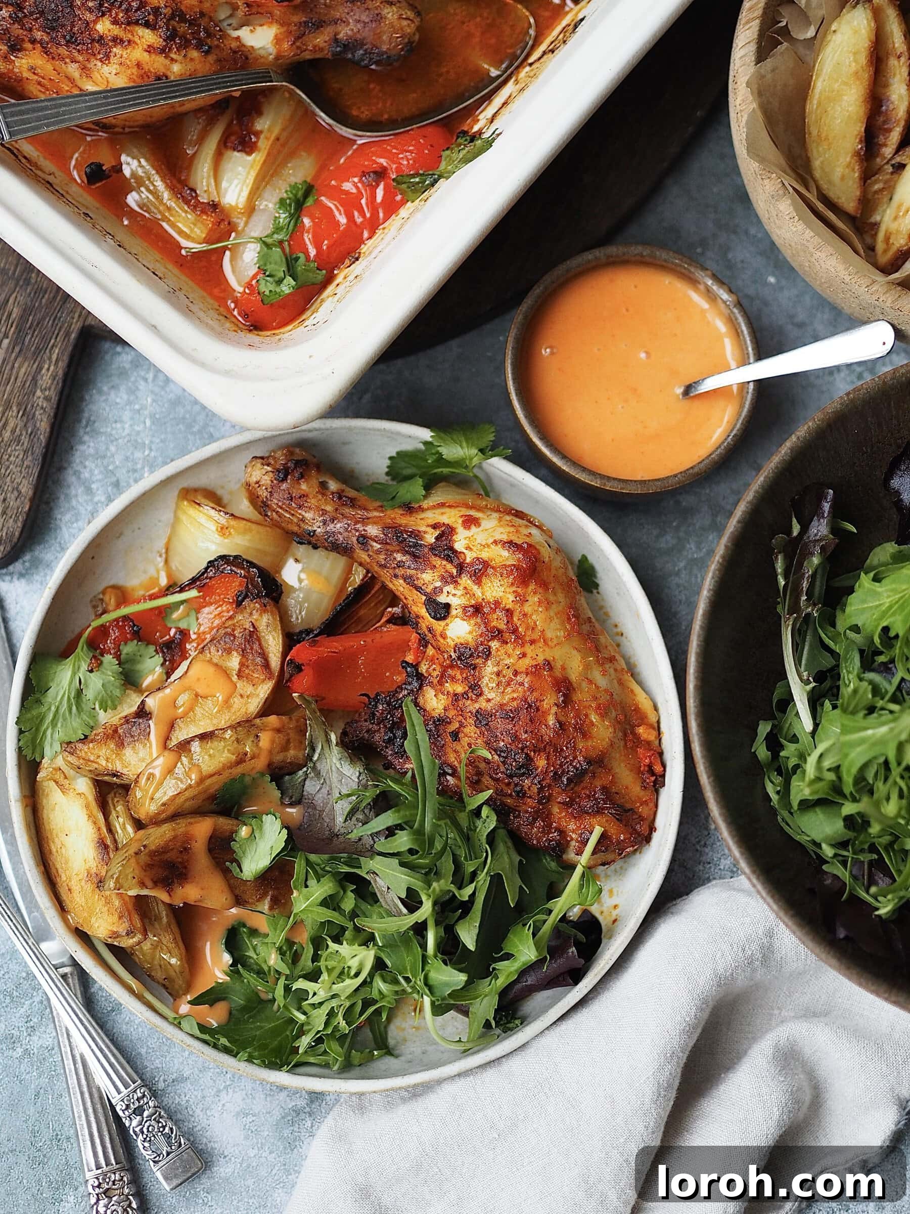 Zesty Peri Peri Chicken with Golden Potato Wedges 2 Plated peri peri chicken legs with potato wedges and salad.