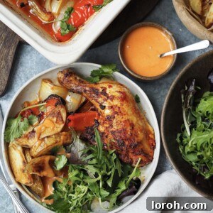Plated peri peri chicken legs with potato wedges and salad.