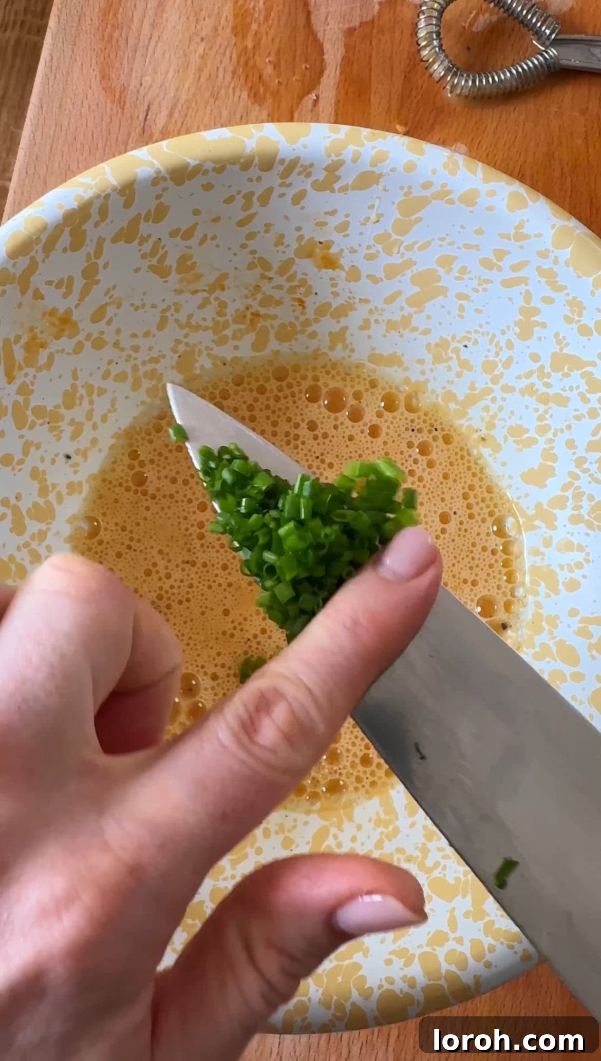 Step one: Whisking eggs in a small bowl with seasoning.