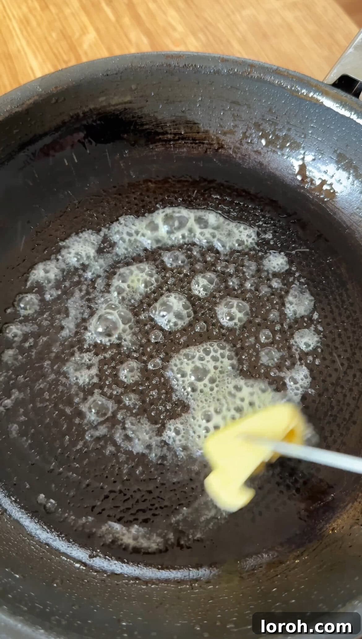 Step two: Melting butter in a non-stick frying pan.