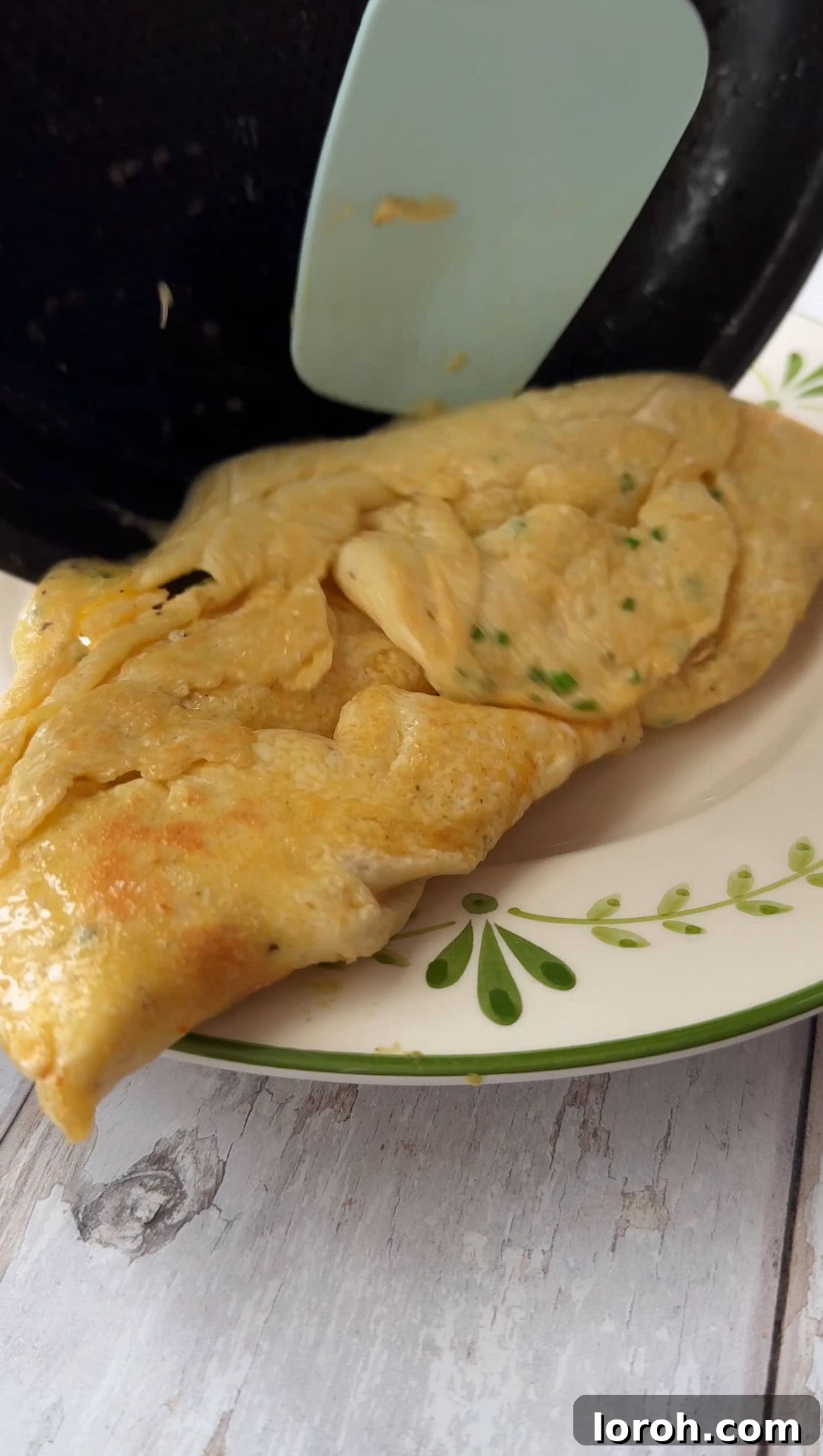 Step five: Rolling one third of the omelette.