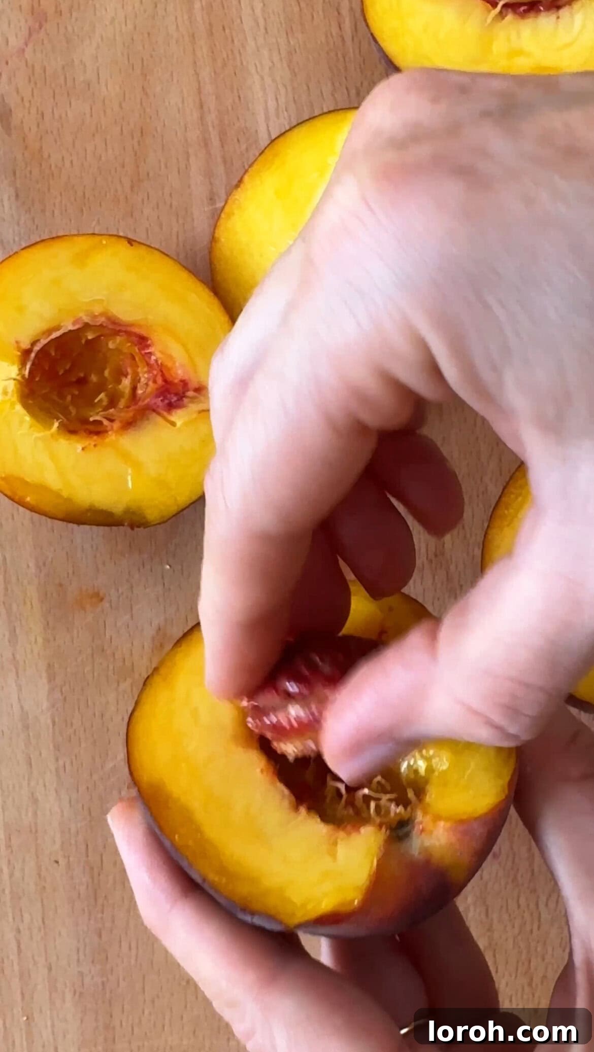Preparing peaches by slicing around the pit for peaches and cream.