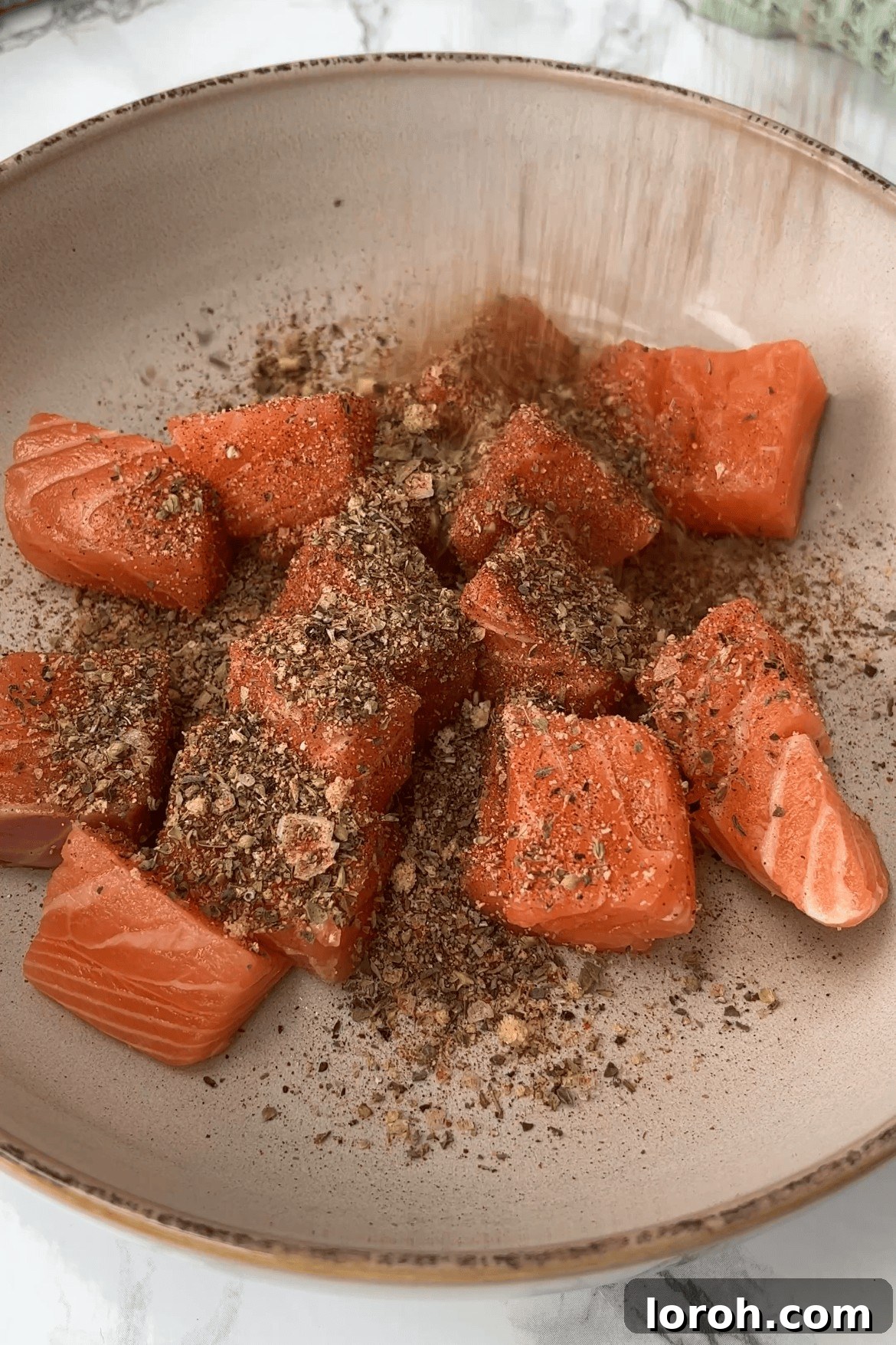 Fiery Salmon Power Bowl 3 seasoning the spicy salmon.