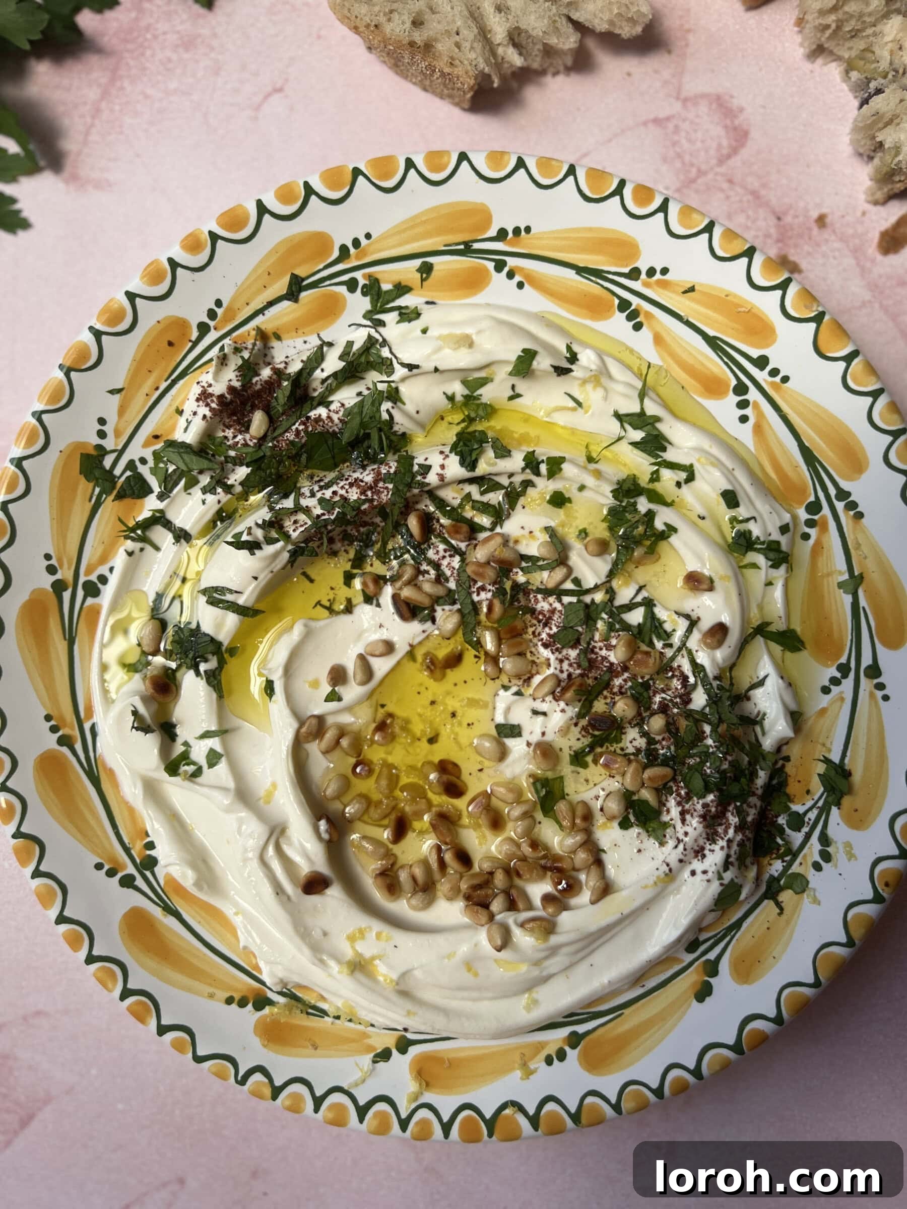 Zesty Garlic Labneh 3 Beautifully presented garlic labneh, ready to be enjoyed with a side of crisp fresh bread and a colorful assortment of fresh vegetables, showcasing its versatility as a healthy and satisfying dip for any occasion.