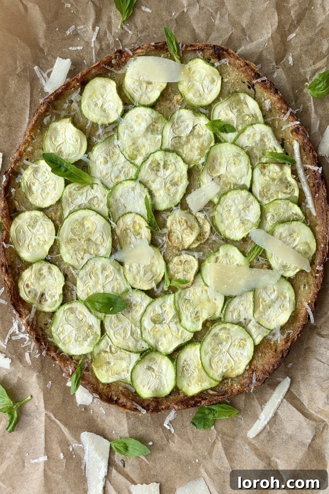 Rustic Italian Zucchini Tart 9 A freshly baked, golden and crispy Scarpaccia on a wooden board, garnished with fresh herbs and Parmesan, ready to be enjoyed.