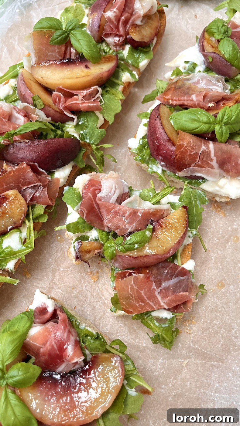 grilled peach and burrata ciabatta. A beautifully composed plate featuring the appetizer with fresh basil, showcasing its vibrant colors and appeal.