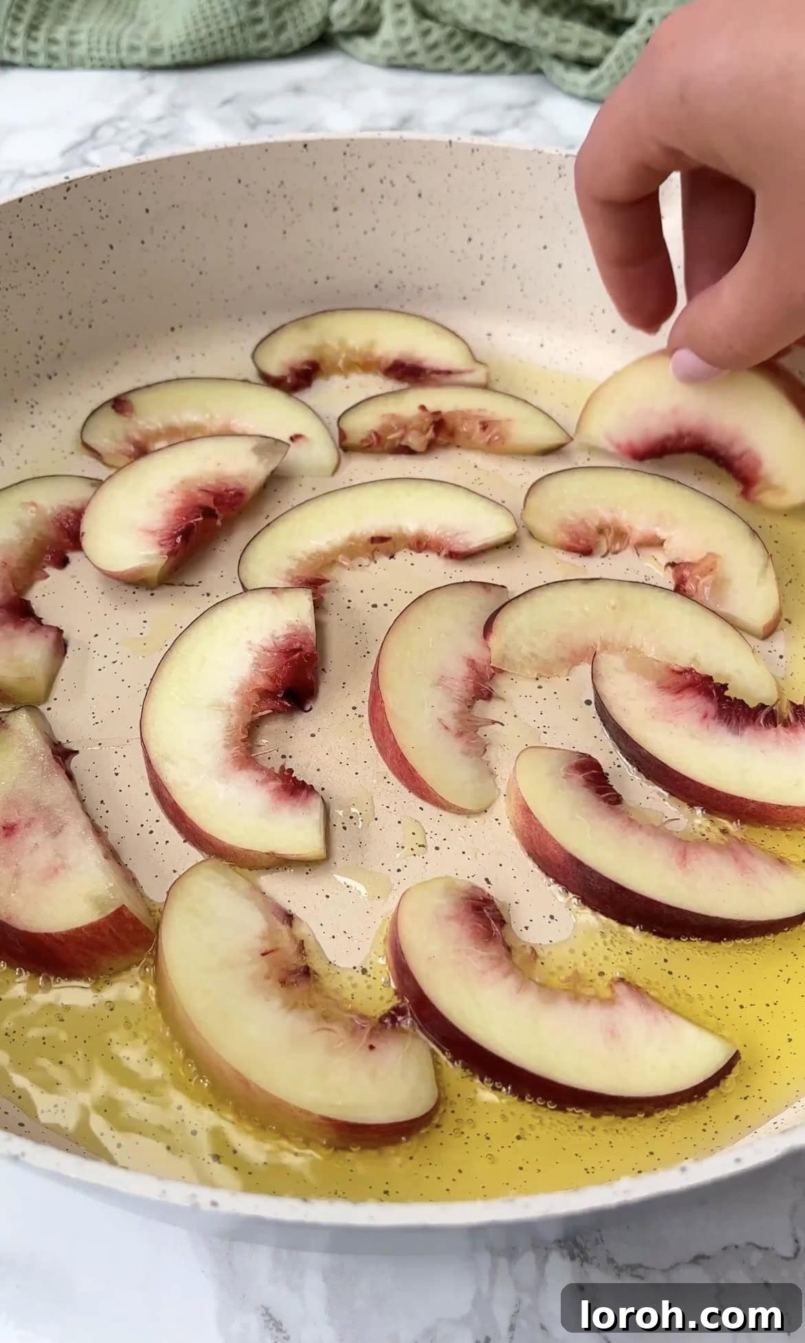 frying peaches. Sliced peaches being seared on a hot pan, developing golden-brown grill marks and caramelization.