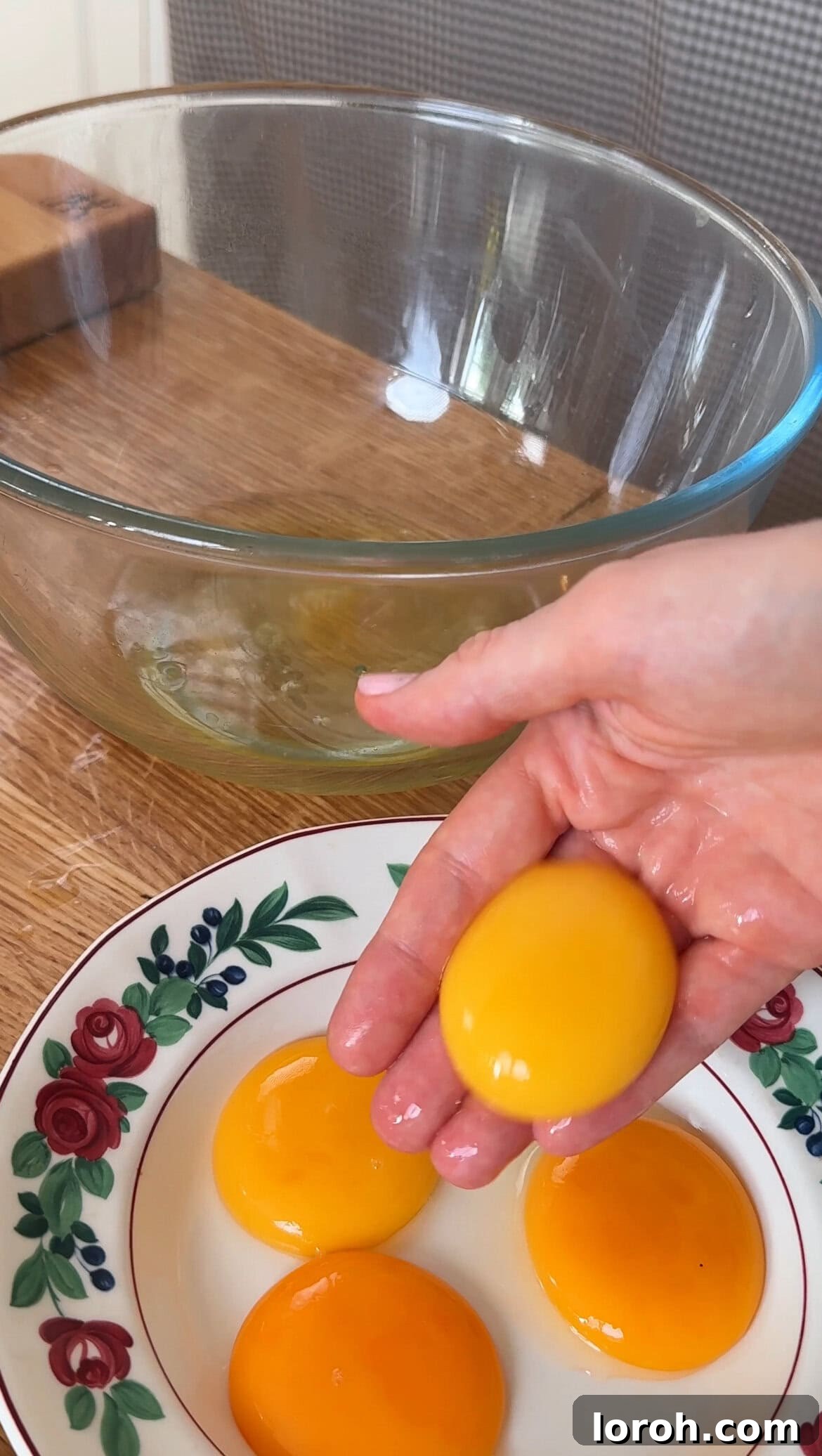 Step one: Separating egg yolks from egg whites with clean fingers.
