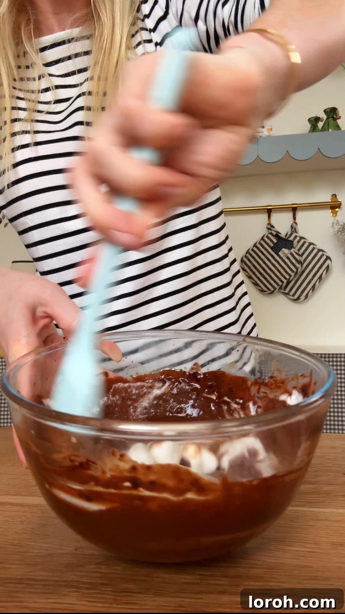 Step four: Mixing one-third of whisked egg whites into the chocolate mixture to lighten it.