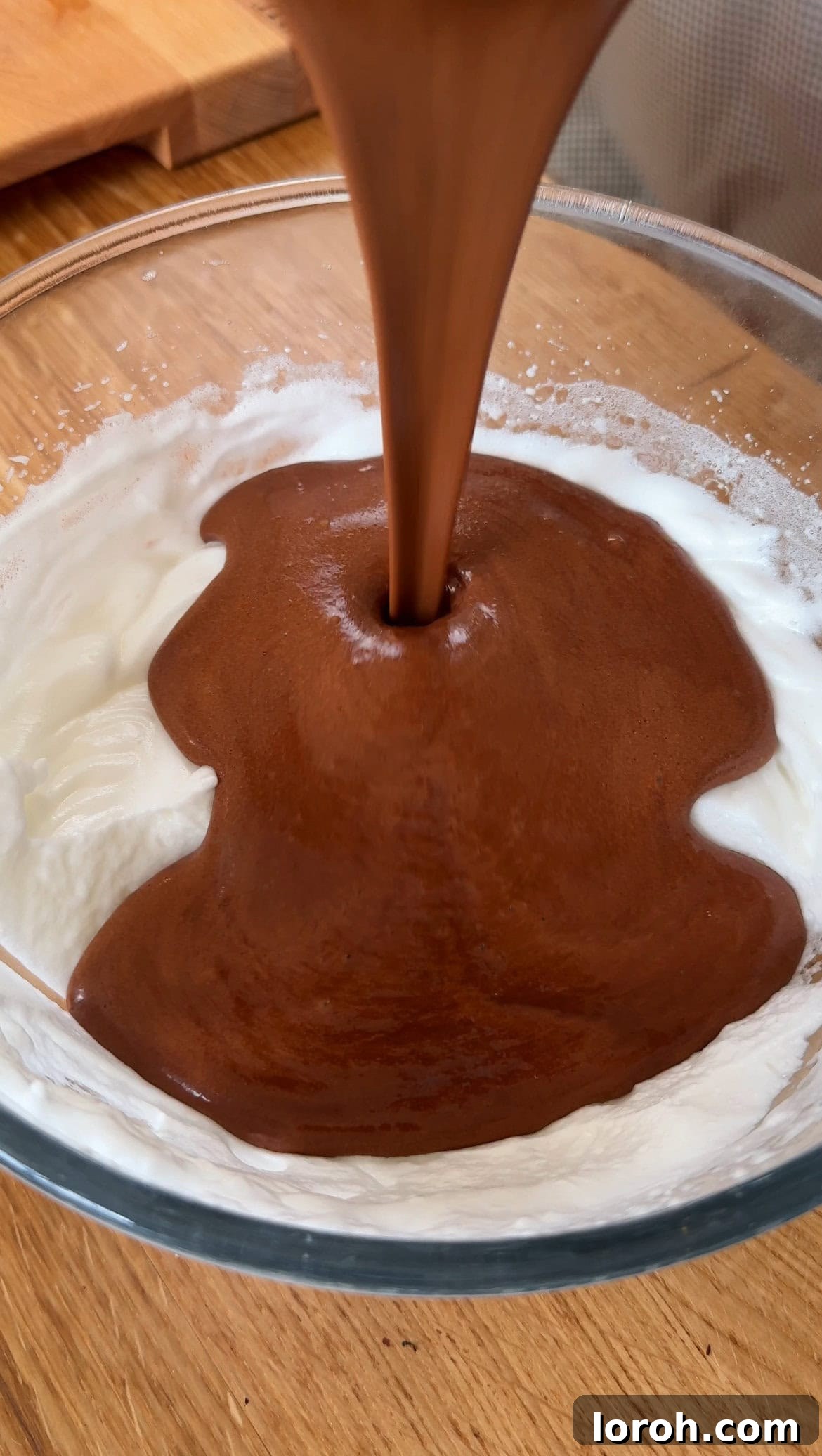 Step five: Gently folding the loosened chocolate mixture into the remaining egg whites.