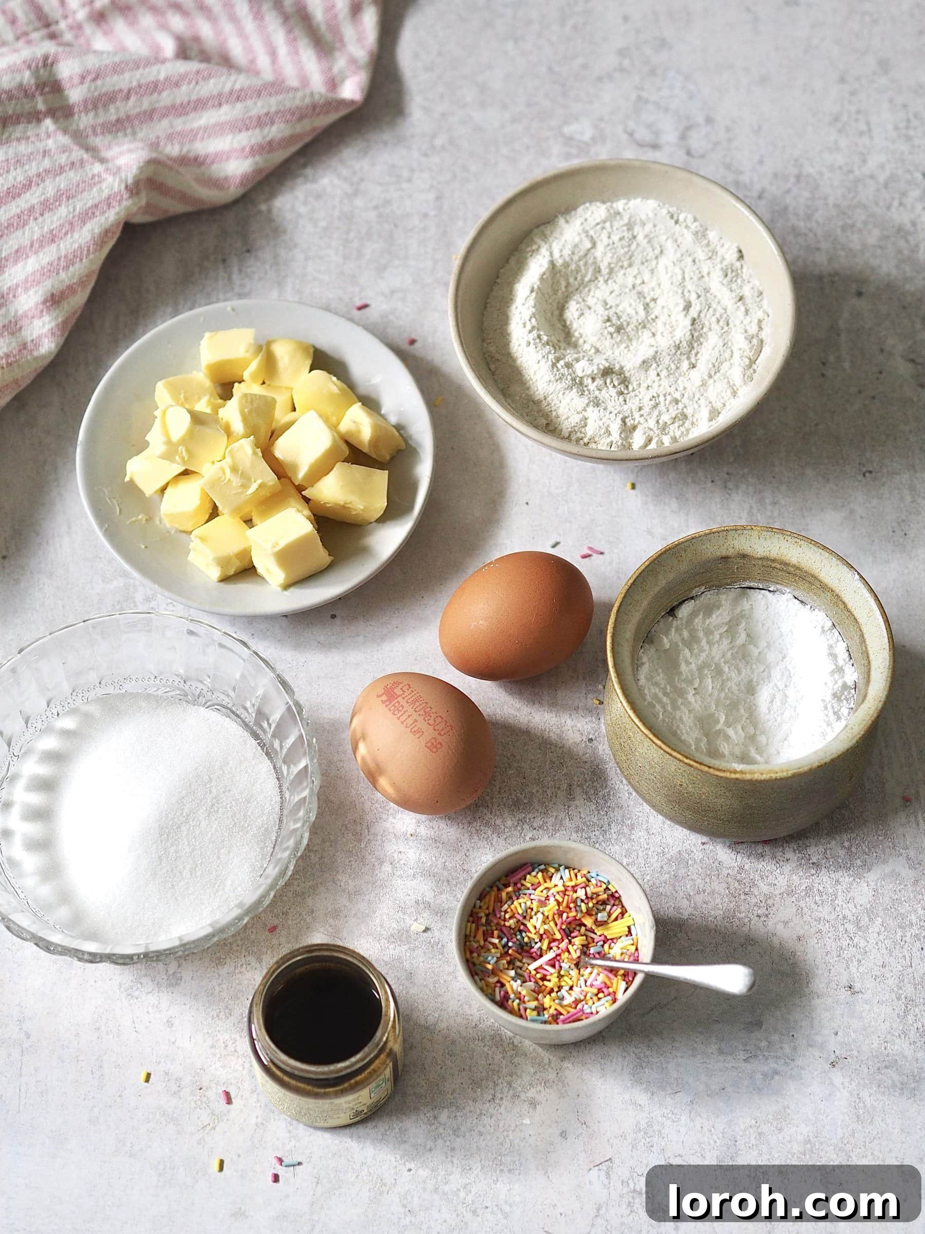 Classic Sprinkle Sponge with Golden Custard 3 All the essential ingredients for the school sprinkle sponge cake meticulously measured and placed into individual bowls, ready for baking.