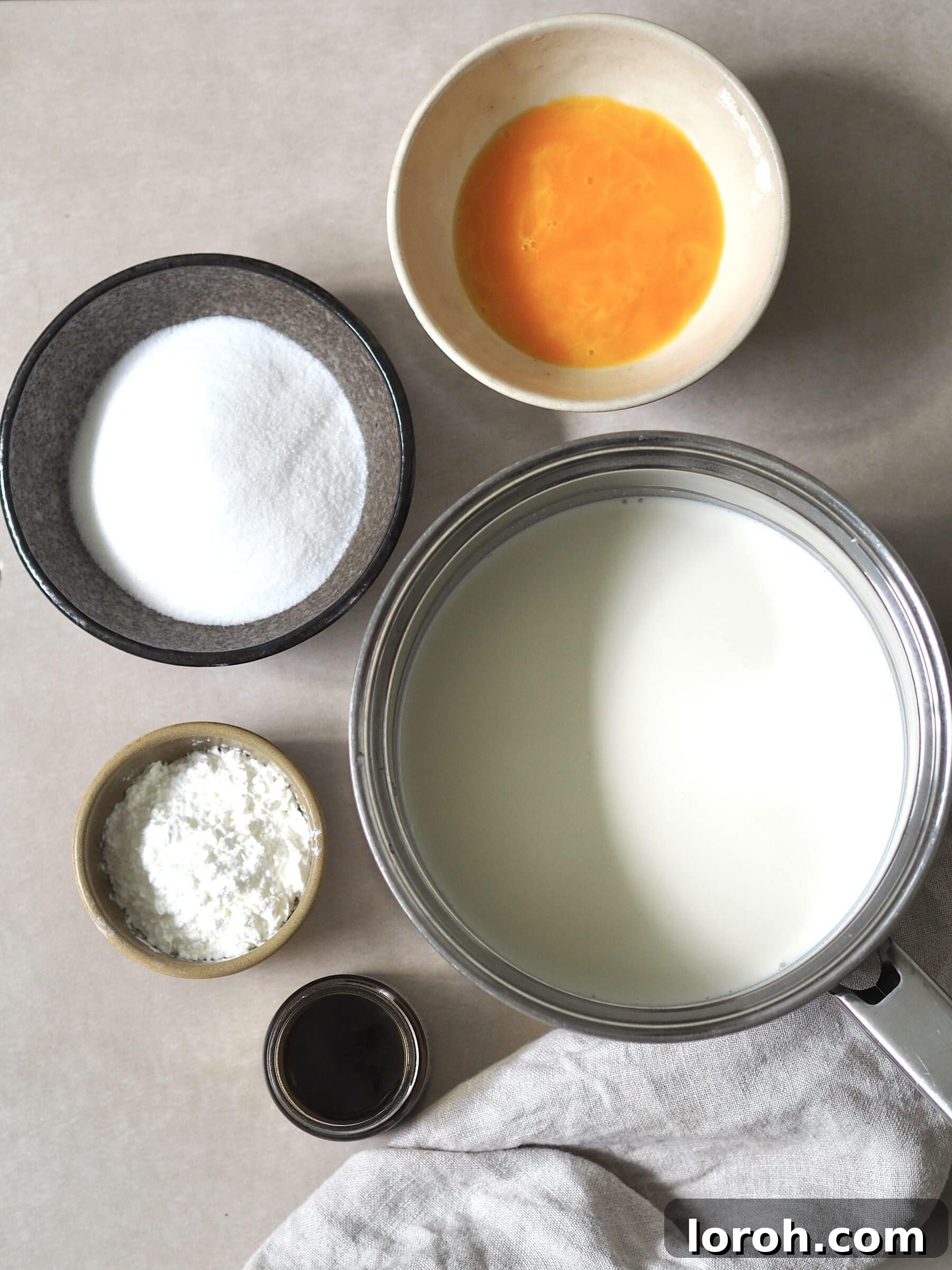 Classic Sprinkle Sponge with Golden Custard 4 Ingredients for making homemade vanilla custard, carefully measured into bowls, showcasing the readiness for the custard preparation.
