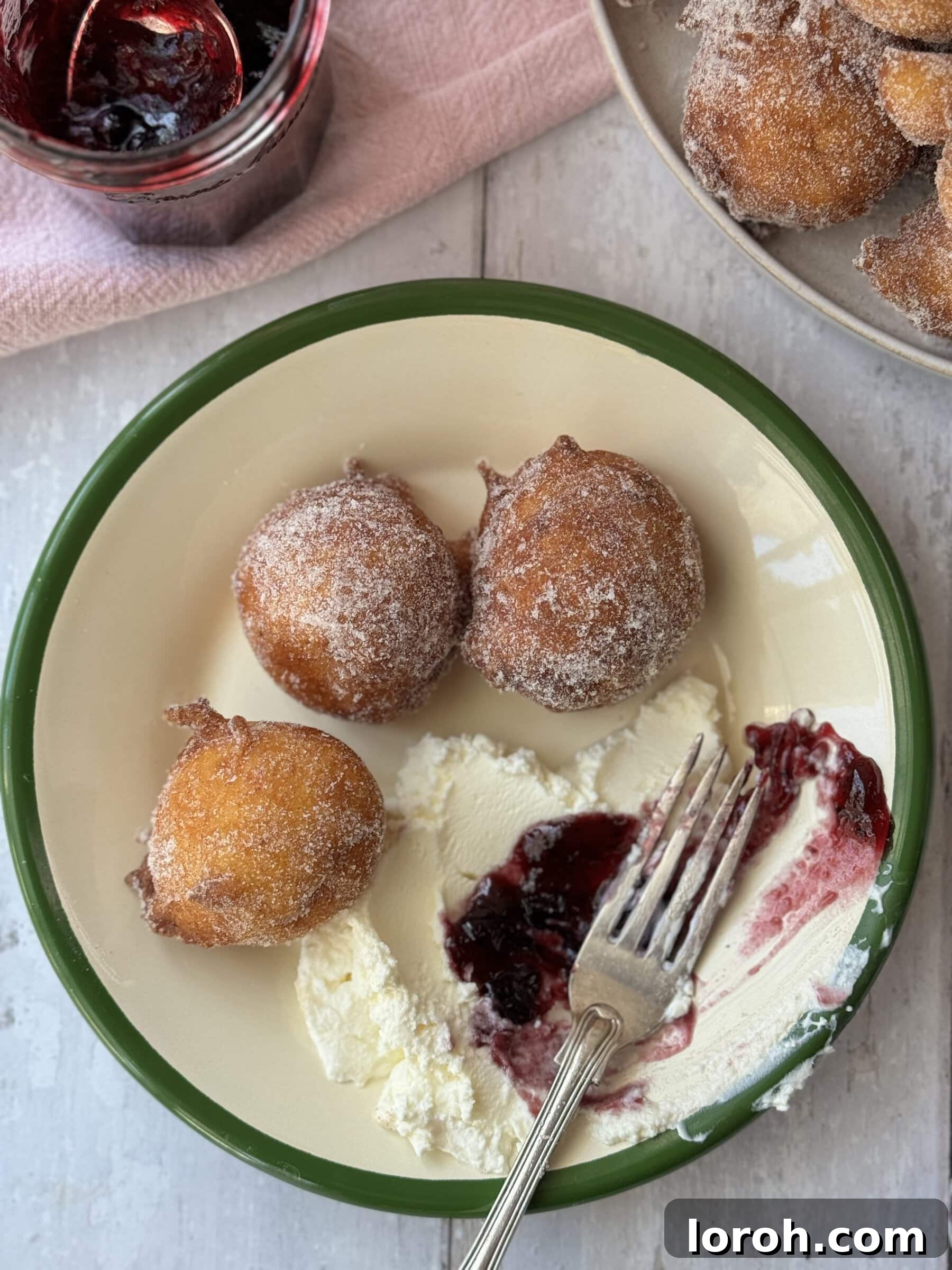 Pillowy Italian Sfingi Doughnuts 3 Serving suggestion for Sfingi doughnuts with small bowls of vibrant red jam and creamy mascarpone cheese.