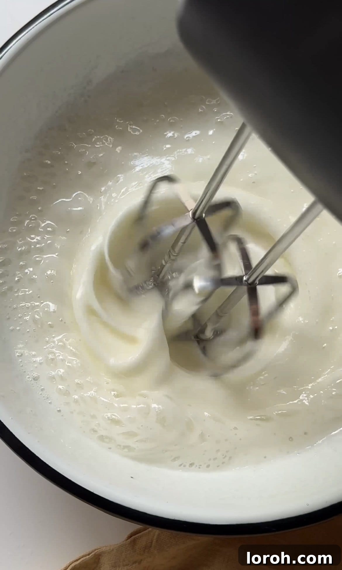 beating sugar and egg whites together.