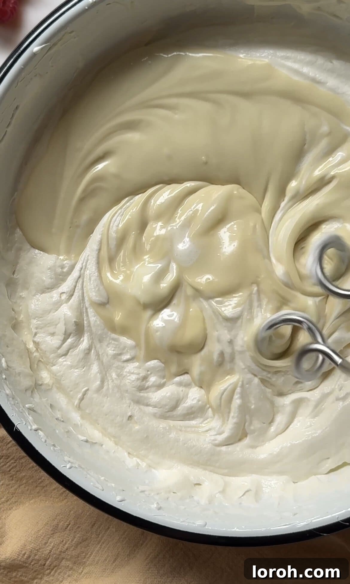 beating melted white chocolate into the buttercream.