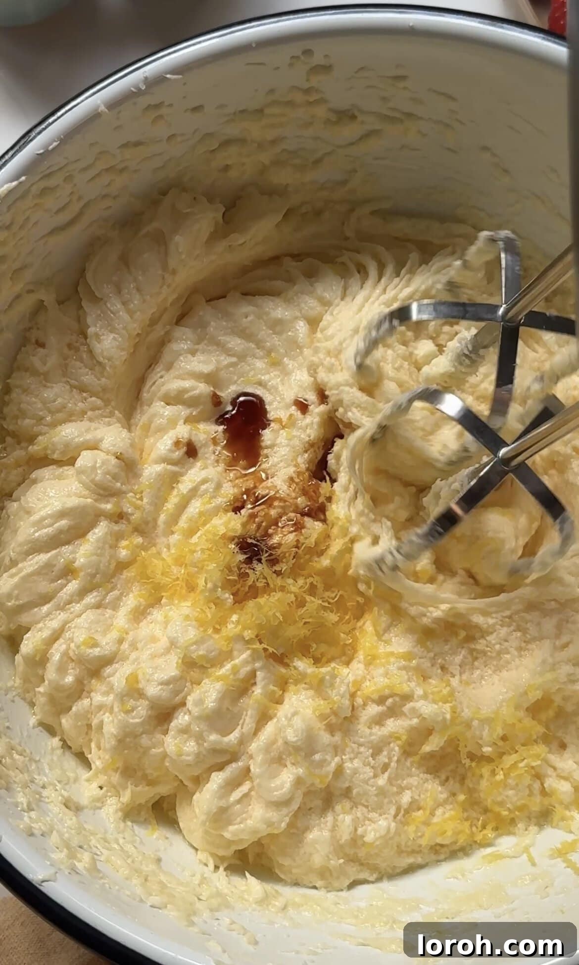 beating eggs and vanilla together.