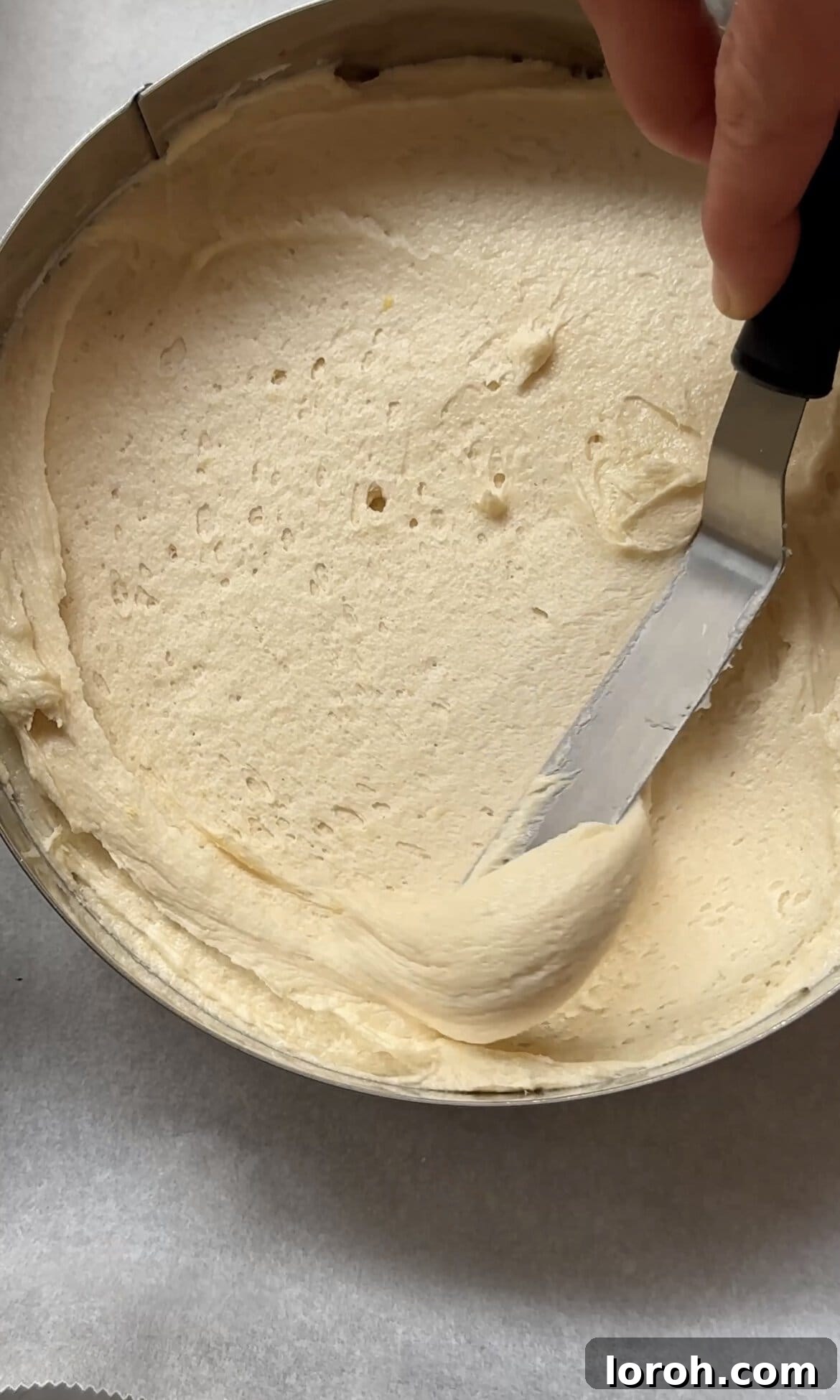 smoothing cake batter into the tins.