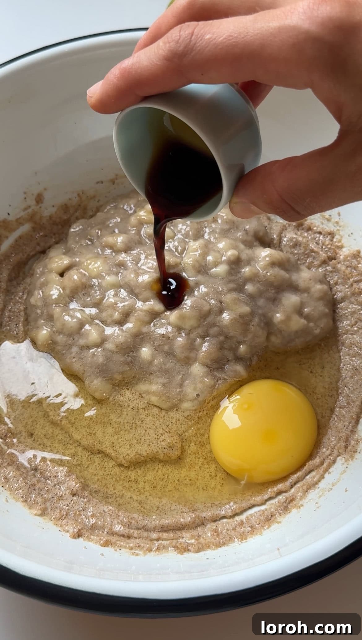 Adding vanilla paste to the banana muffin batter.