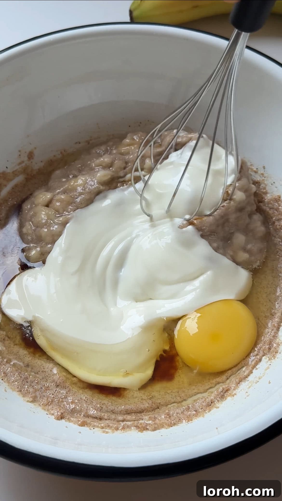Adding Greek yogurt to the muffin batter.