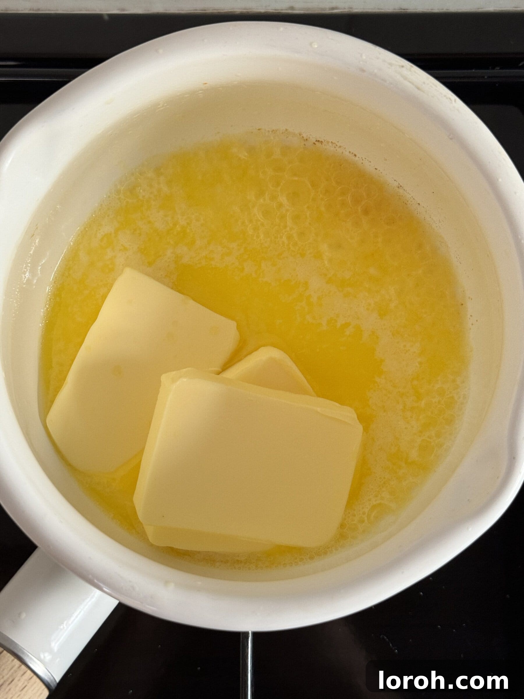 Butter melting in a saucepan over heat.
