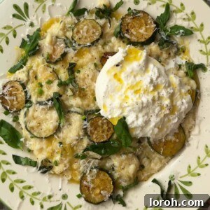 creamy zucchini risotto in a bowl with mozzarella on top.