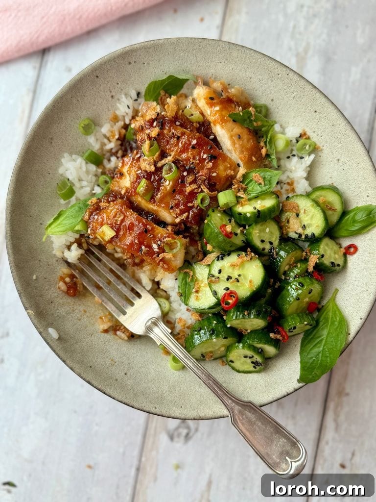 Sticky Soy Garlic Chicken 11 Garlic and Soy chicken in a bowl with rice and cucumber salad, ready to eat