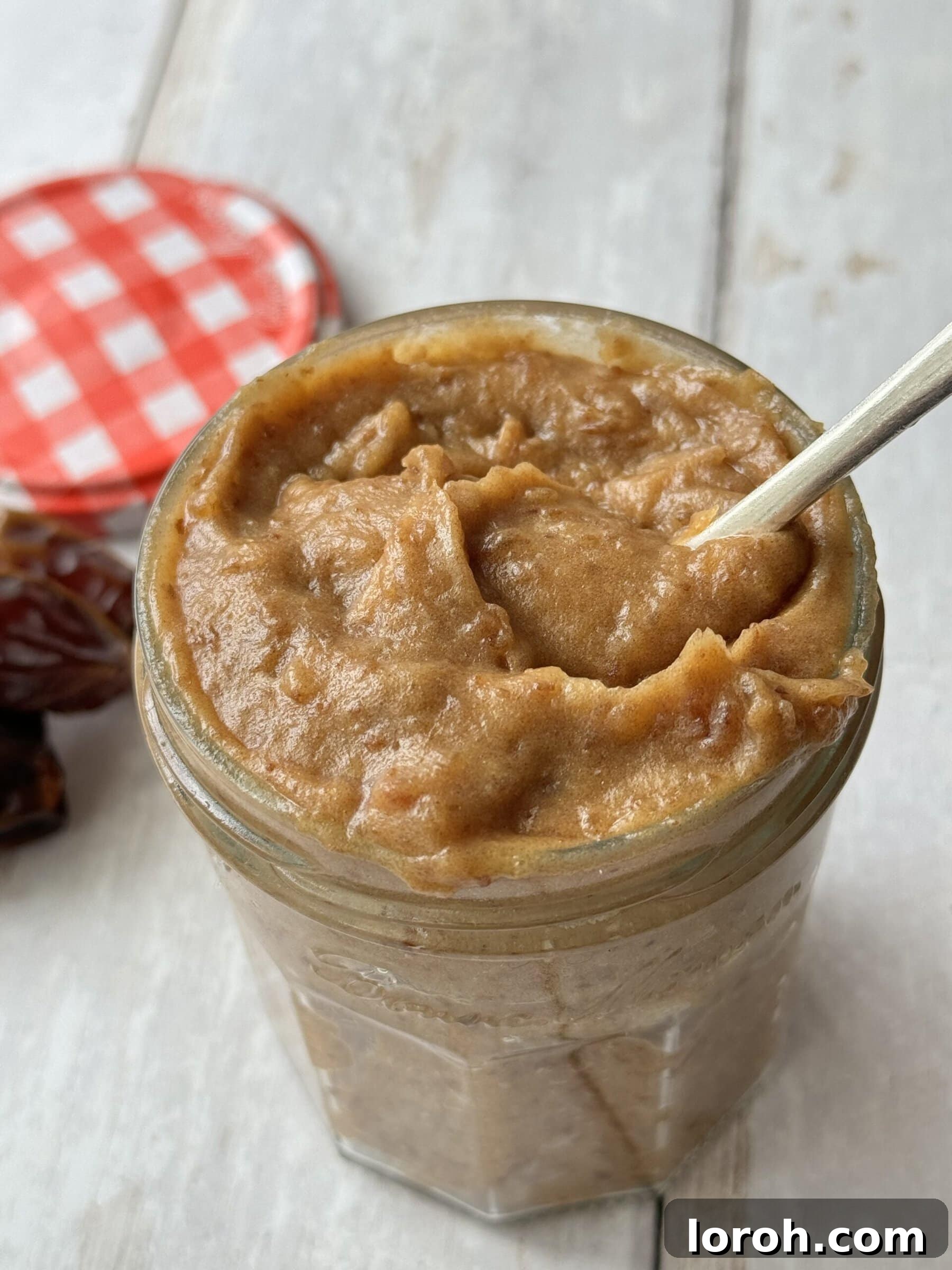 Easiest date caramel recipe with a spoon in a jar