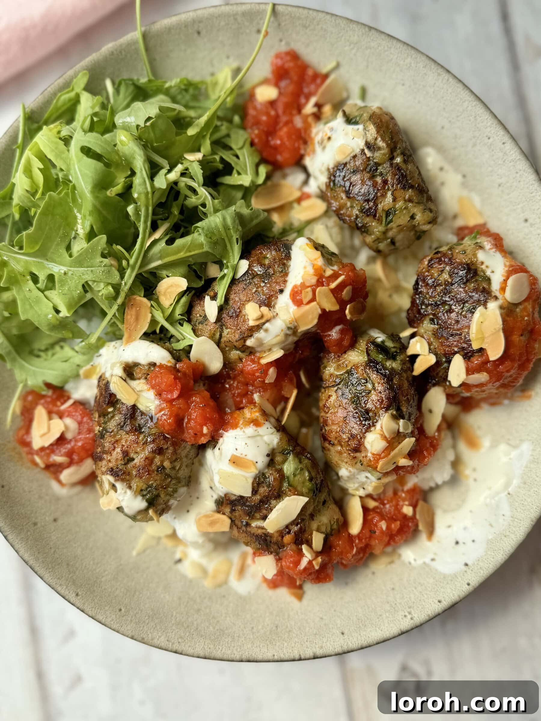 Spicy Tomato Chicken Kofta Bowls 2 Serving perfectly cooked Chicken Koftas with rice, tomato sauce, and lemon yogurt.