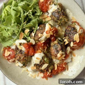 Serving Chicken Koftas with rice and sauce.
