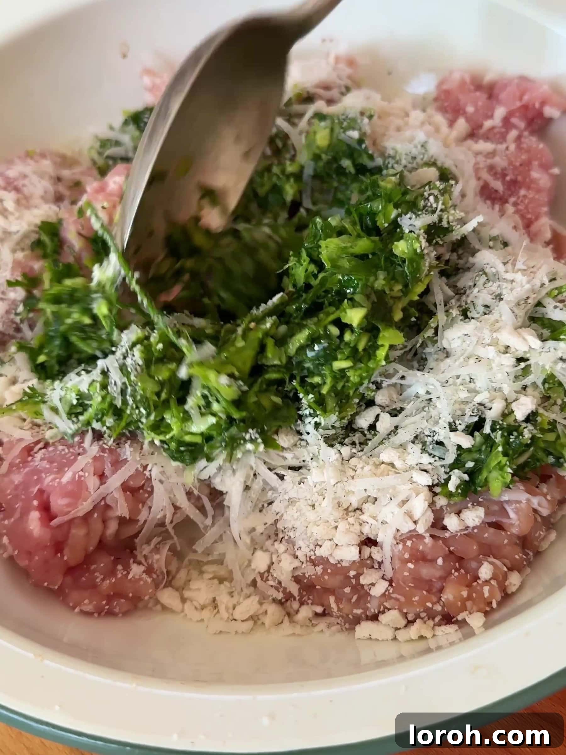 Spicy Tomato Chicken Kofta Bowls 5 Mixing chicken mince with the herb mixture in a large bowl.