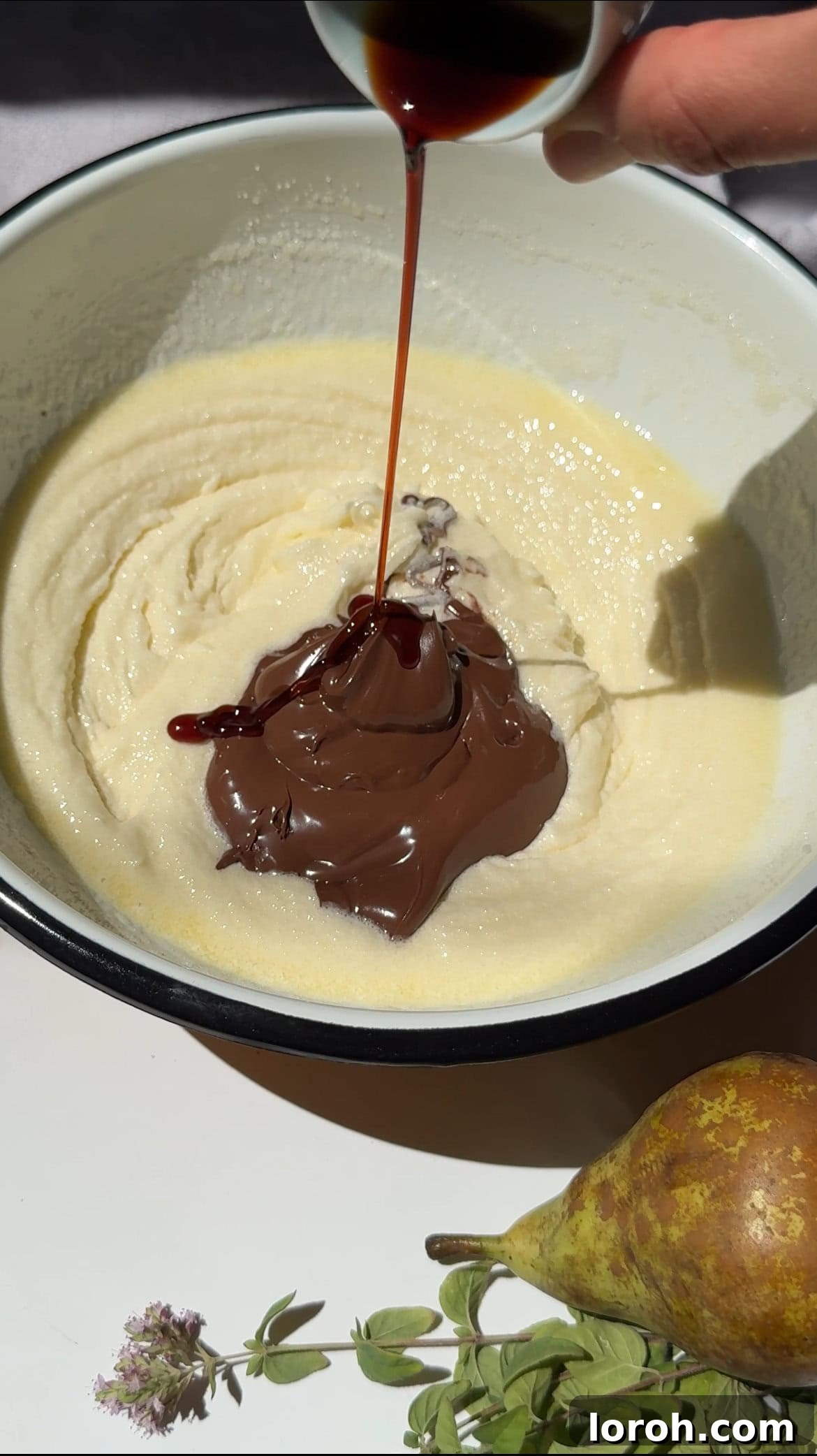 Decadent Chocolate Pear Dream 4 Chocolate and hazelnut spread and vanilla extract being added to the creamed butter and sugar mixture.