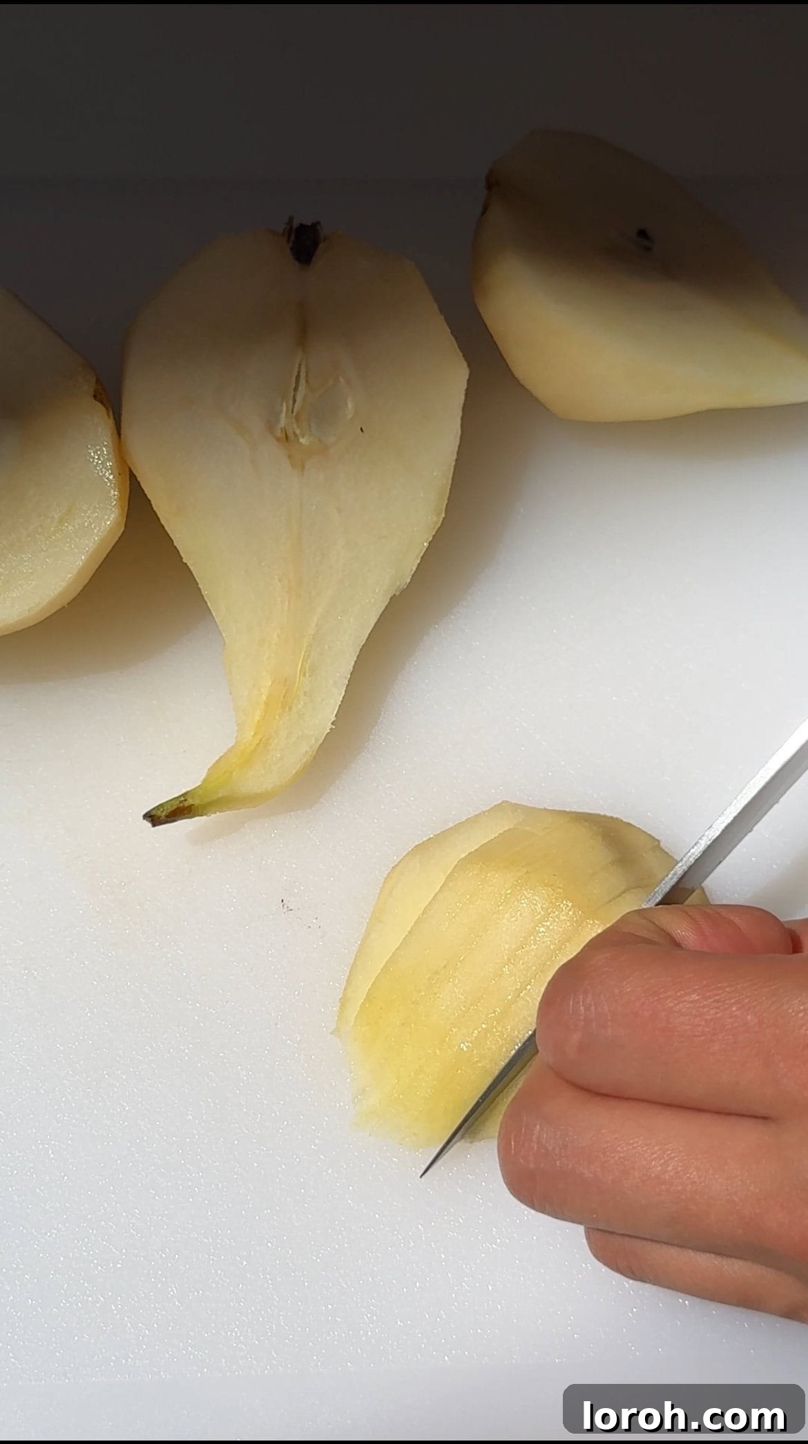 Decadent Chocolate Pear Dream 6 Half of the cake batter placed in a tin, with thinly sliced pears arranged on top.