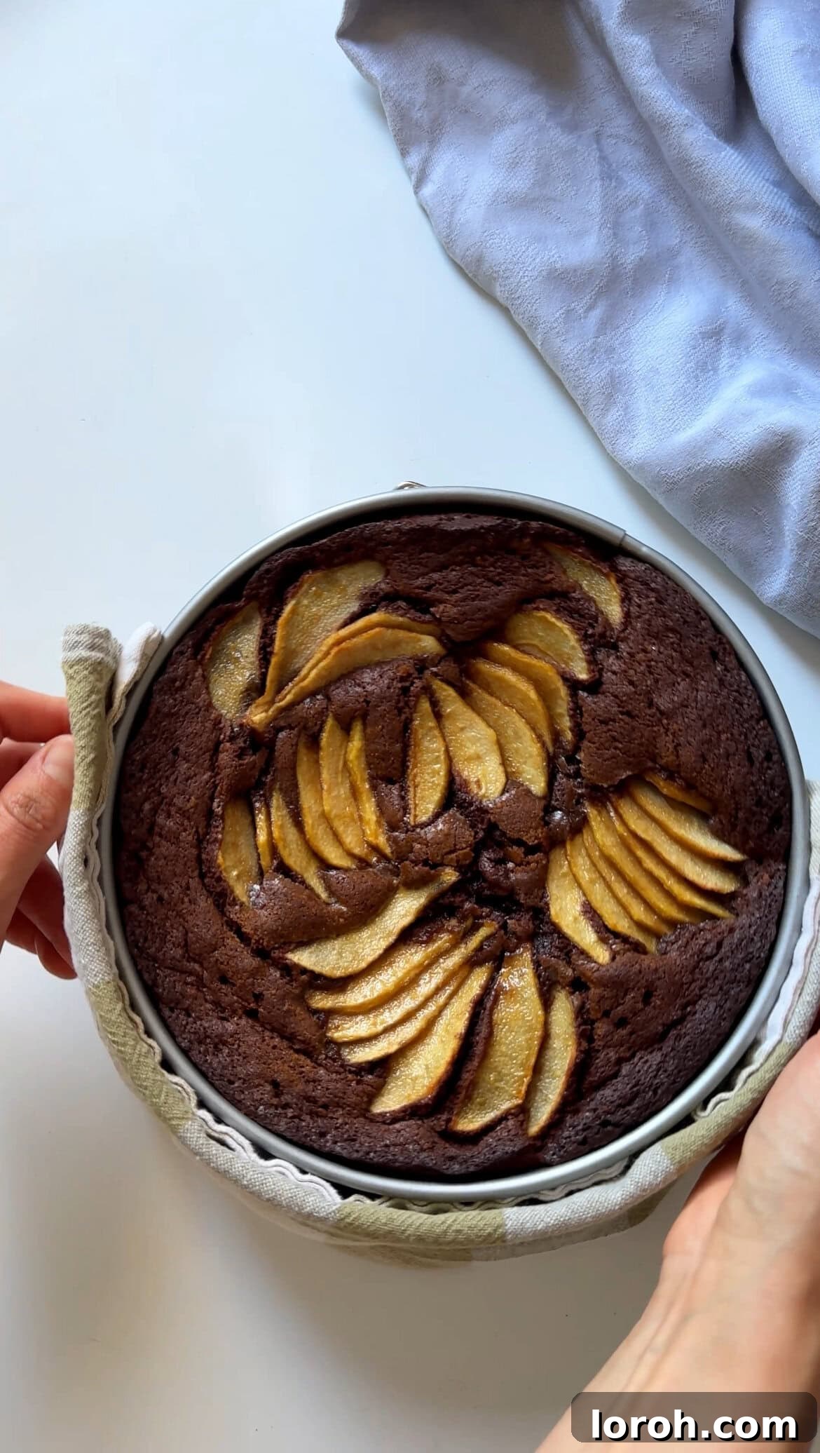 Decadent Chocolate Pear Dream 8 The baked chocolate and pear cake cooling in its tin on a wire rack.