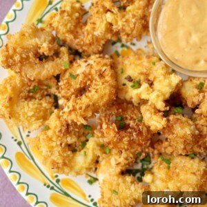 panko shrimp on a plate with dip.