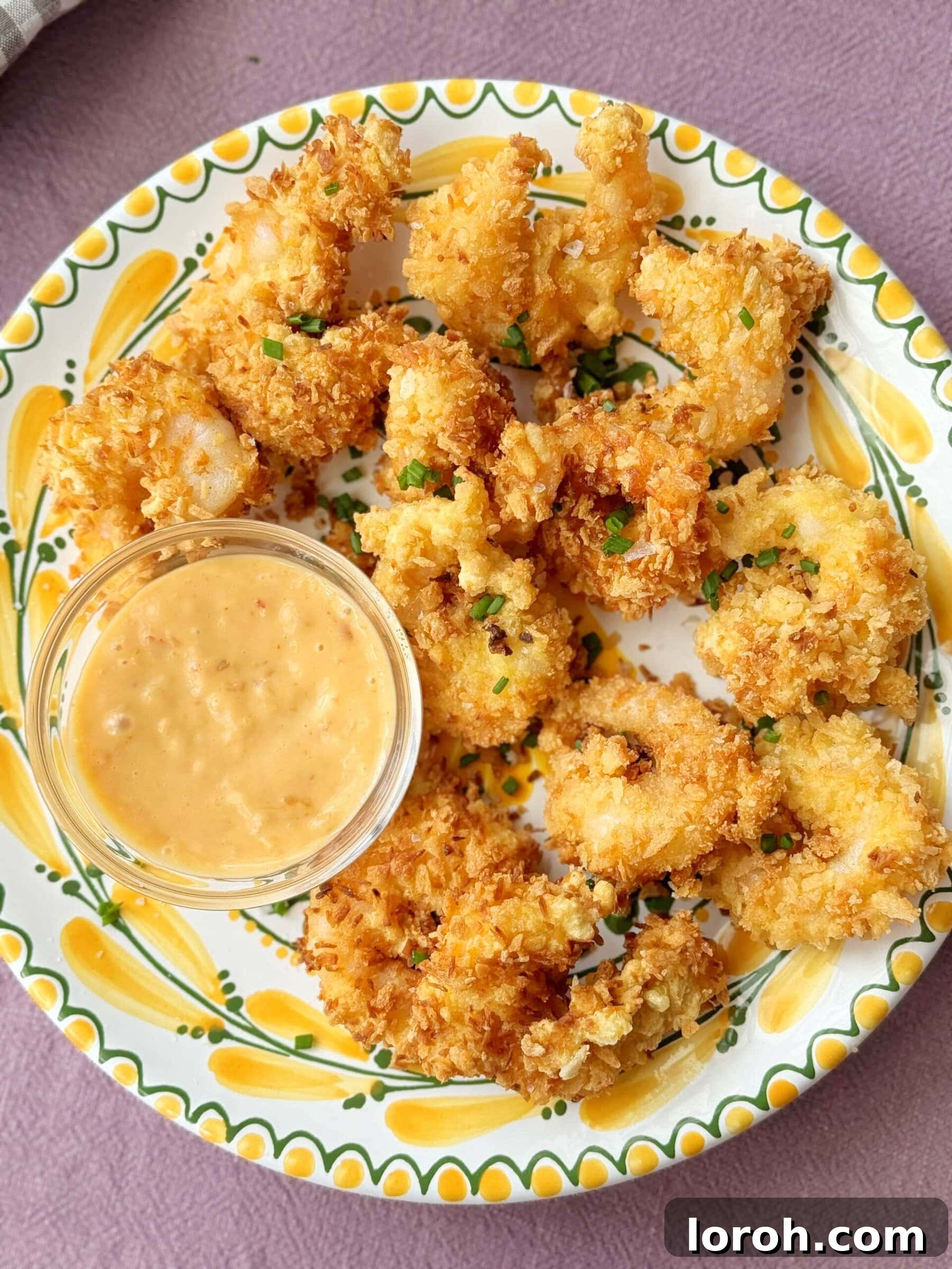 Golden Crispy Panko Shrimp 2 Perfectly fried Panko Shrimp arranged on a plate with a side of creamy dip, ready to be enjoyed.