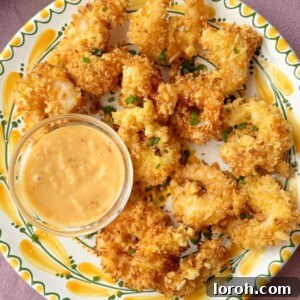 Crispy Panko Shrimp on a plate with dip and fresh chives.