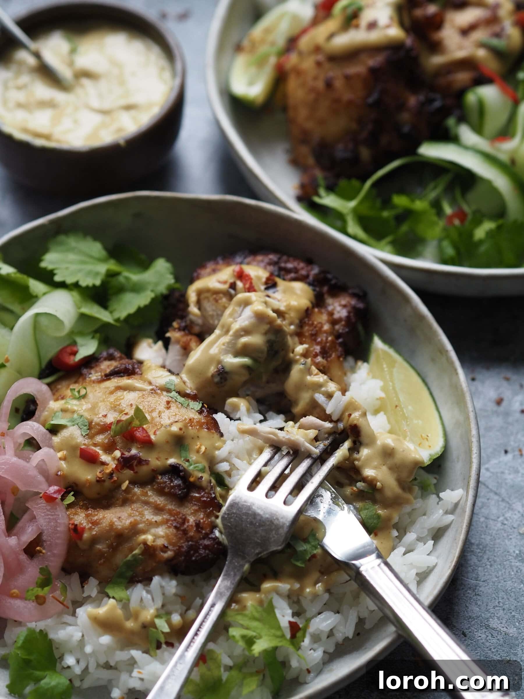 Close-up of cooked chicken satay thighs in a bowl