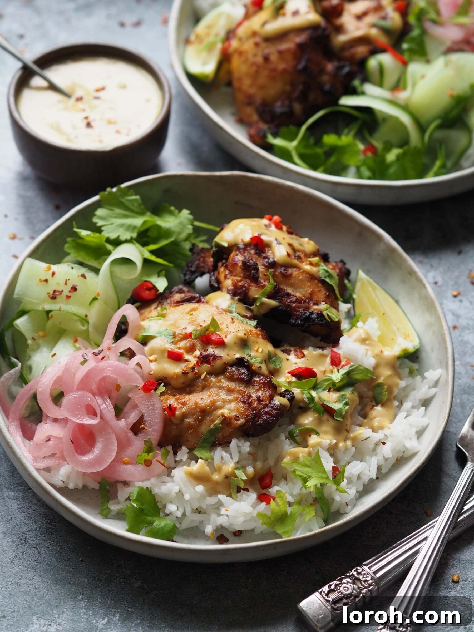 Prepared chicken satay rice bowls, showcasing the assembly of ingredients