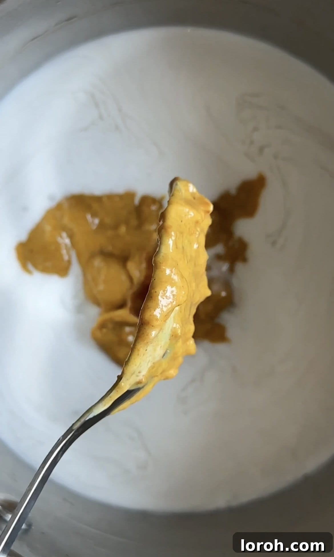 Satay sauce ingredients simmering with coconut milk