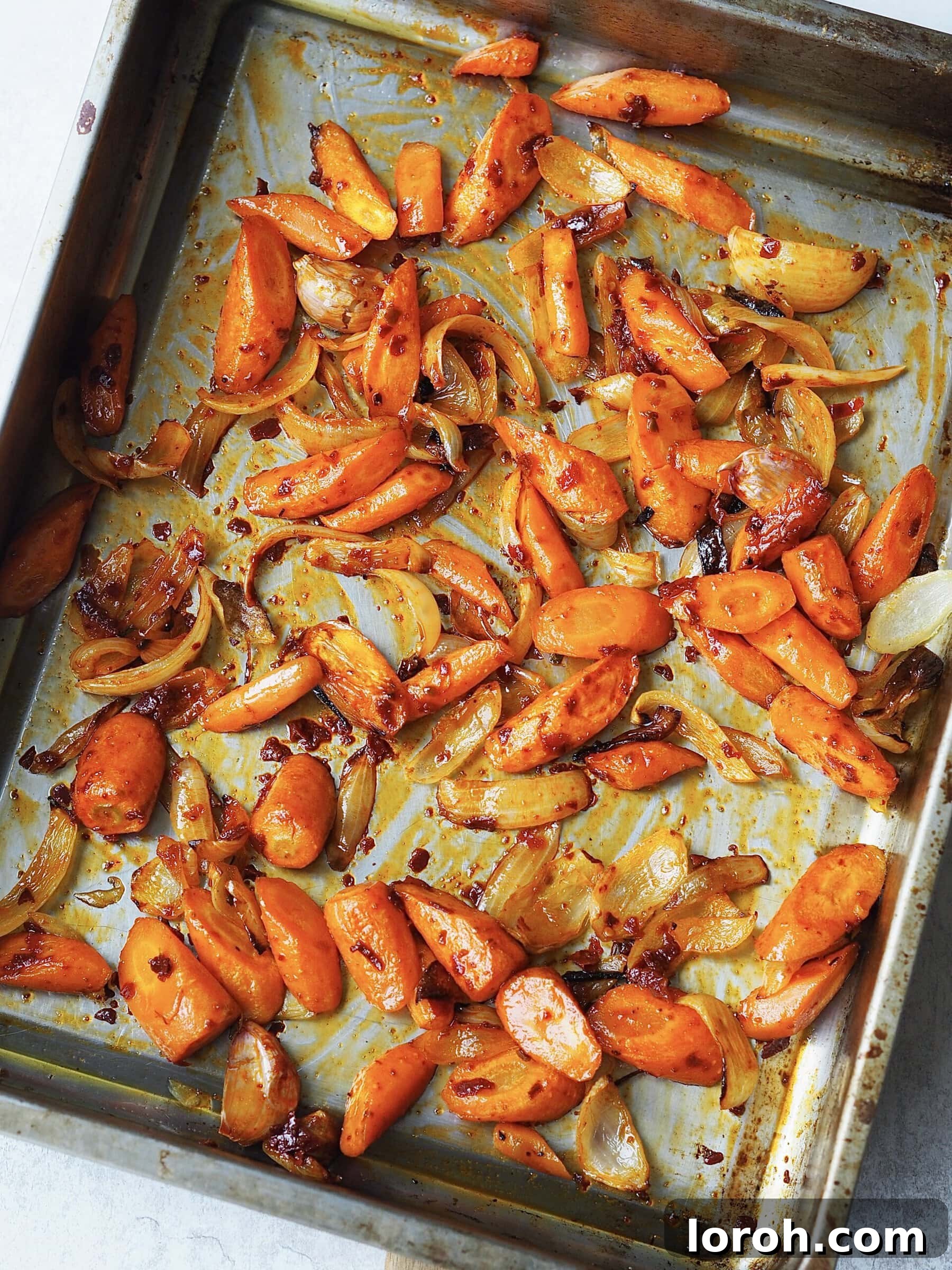 Smoky Harissa Carrot Velouté 7 Roasted vegetables tossed with harissa on a roasting tray.