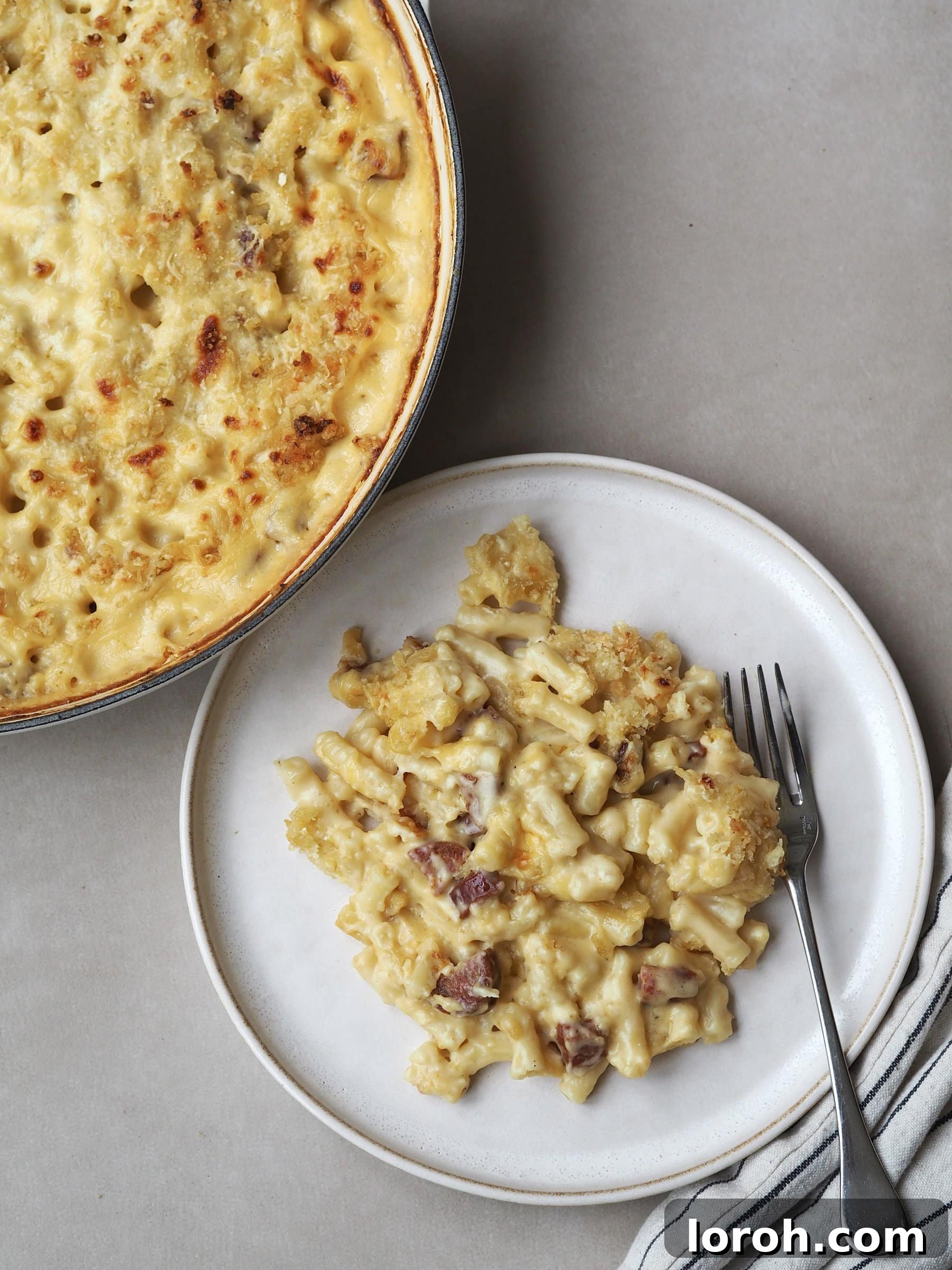 Decadent Gouda Mac and Cheese 11 A serving of baked Gouda Mac and Cheese on a plate, showing the creamy interior and crispy topping.