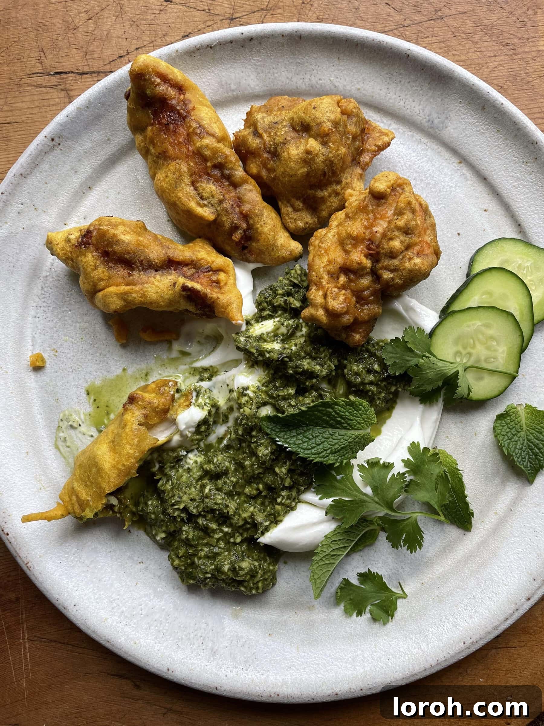 Crispy golden Chicken Pakora served hot on a platter.